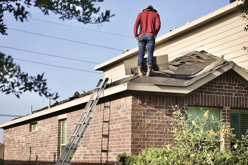 Professional roofer working on a residential roof in Oakbrook Forest